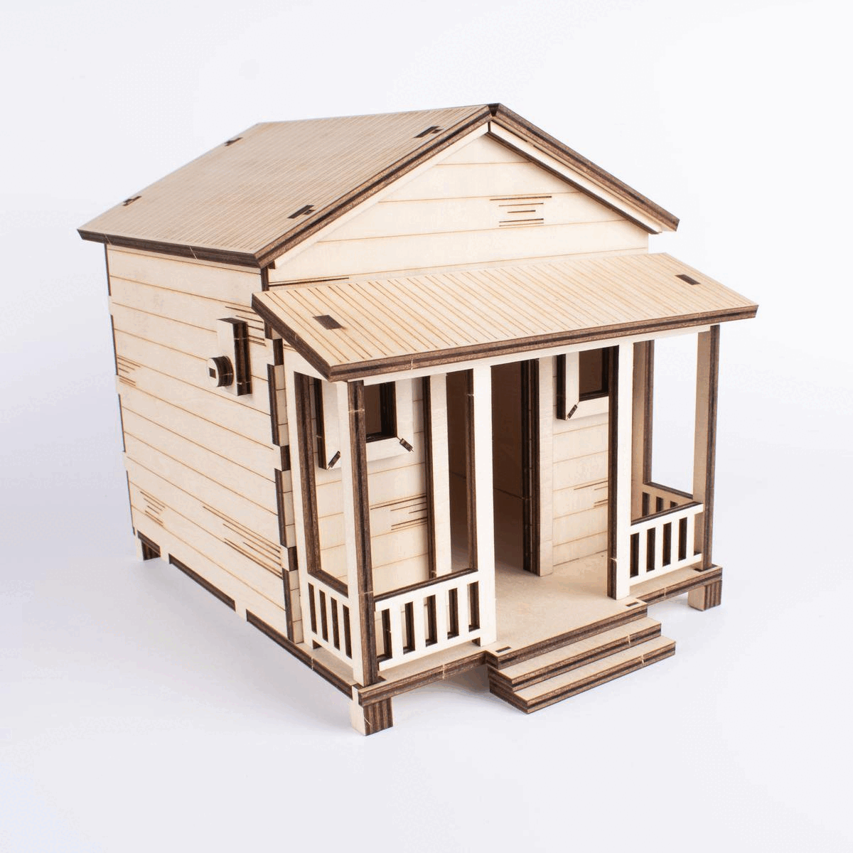 Animación GIF del kit de manualidades Casita de Campo Modelo Alegría, mostrando la casa ensamblada en madera natural que luego se transforma en su versión final pintada con colores vibrantes.