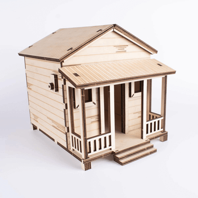 Animación GIF del kit de manualidades Casita de Campo Modelo Alegría, mostrando la casa ensamblada en madera natural que luego se transforma en su versión final pintada con colores vibrantes.