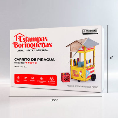 Fotografía de estudio de la caja frontal de El Piragüero Modelo Don Cheo de Estampas Borinqueñas, mostrando el nivel de dificultad, edad recomendada, cantidad de piezas y las dimensiones de la caja.