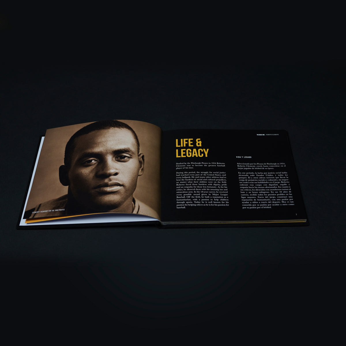 Open Roberto Clemente book showing the Life & Legacy spread with a sepia portrait and bilingual English and Spanish text